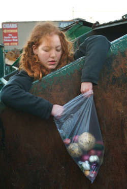 Dumpster diver with bag of vegetables